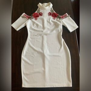 Cream dress with embroidered flowers.